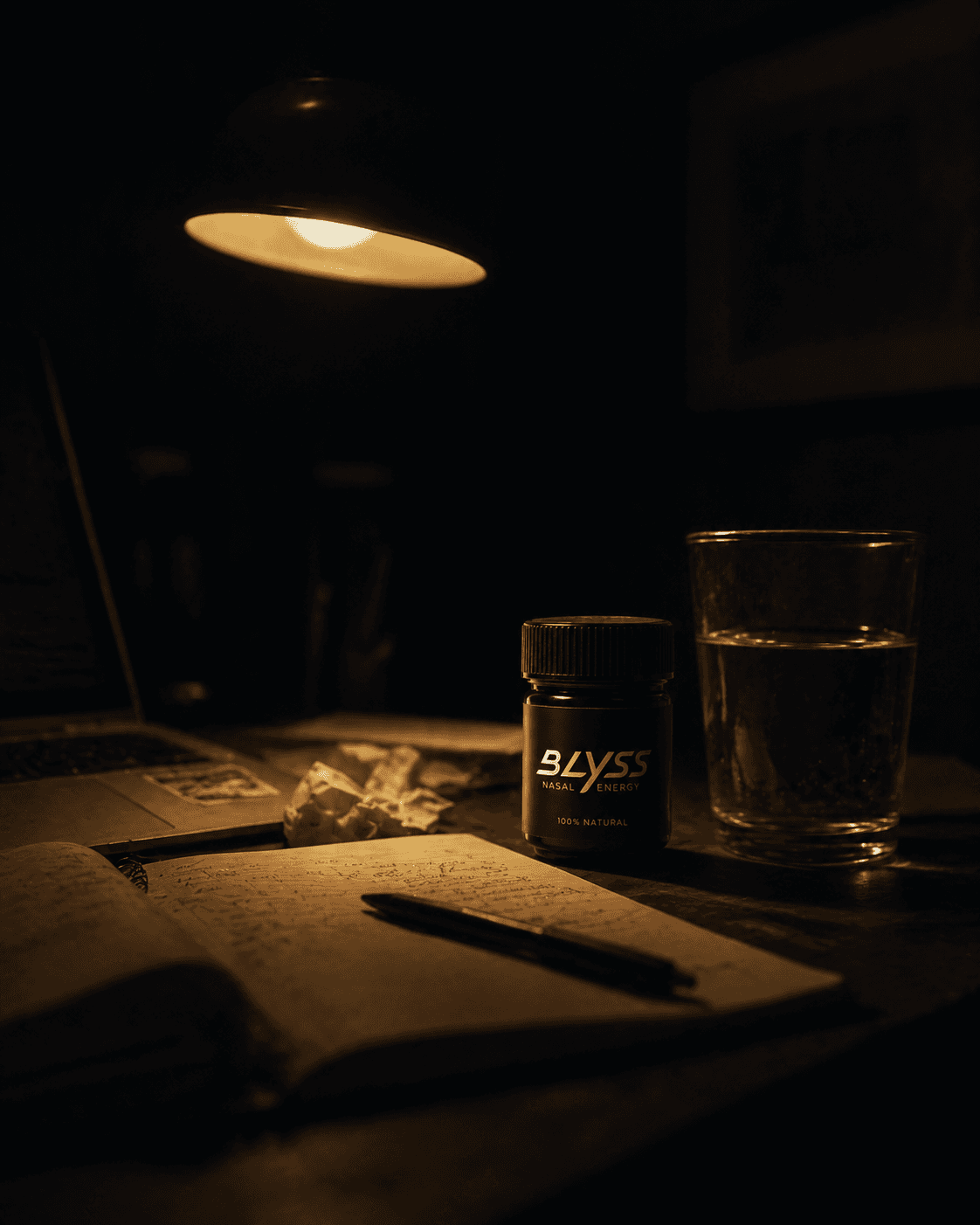 BLYSS inhaler on a desk with open journal and lamp at night