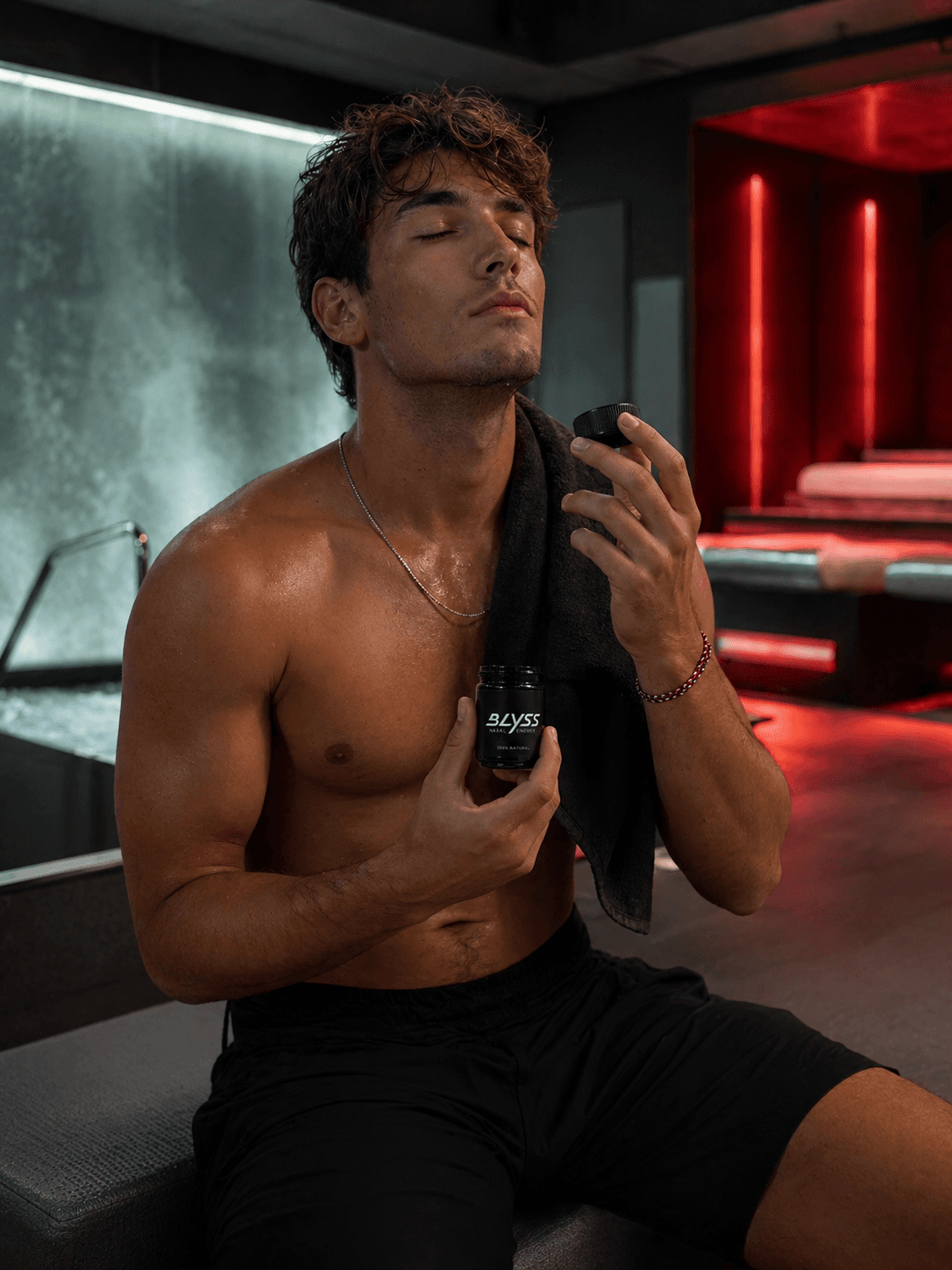 Athlete with towel and BLYSS inhaler post-workout